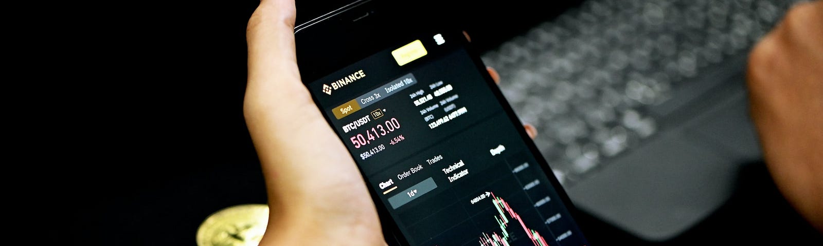IMAGE: Two female hands holding a smartphone with the cryptocurrency exchange Binance on its screen