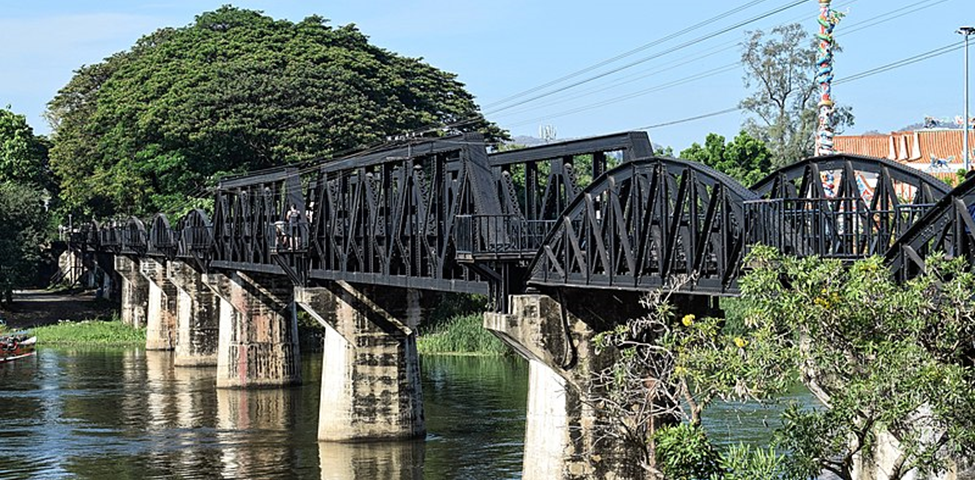 File: Bridge on the River Kwai — tourist plaza.JPG Description of The River Kwai bridge is seen from the tourist plaza (NNE side) in Kanchanaburi, Thailand. Author PumpkinSky This file is licensed under the Creative Commons Attribution-Share Alike 4.0 International license. https://creativecommons.org/licenses/by-sa/4.0/deed.en https://commons.wikimedia.org/wiki/File:Bridge_on_the_River_Kwai_-_tourist_plaza.JPG