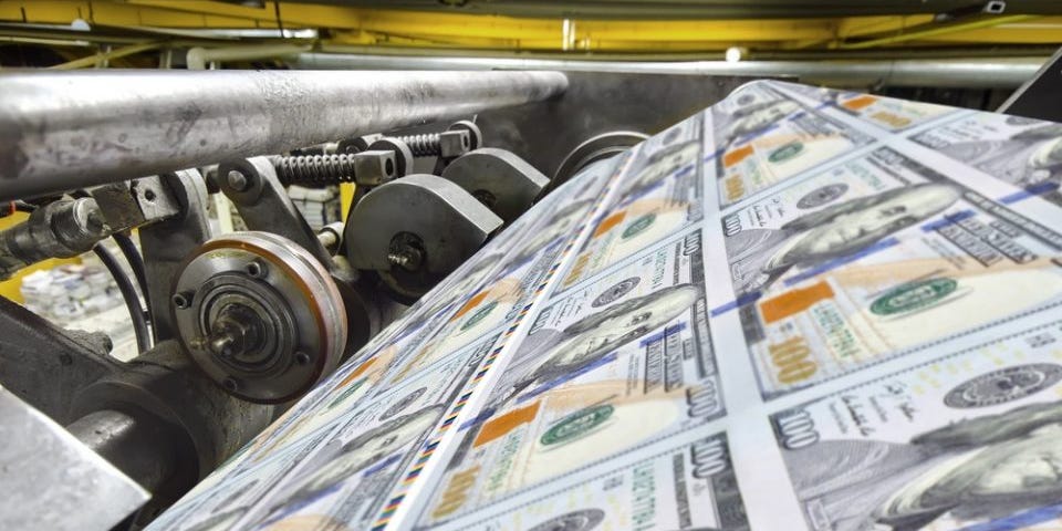 $100 bills roll off the money printer
