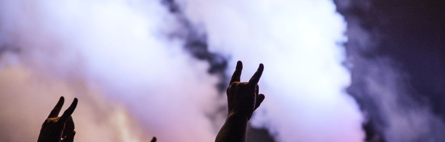 devil horns and a metal concert