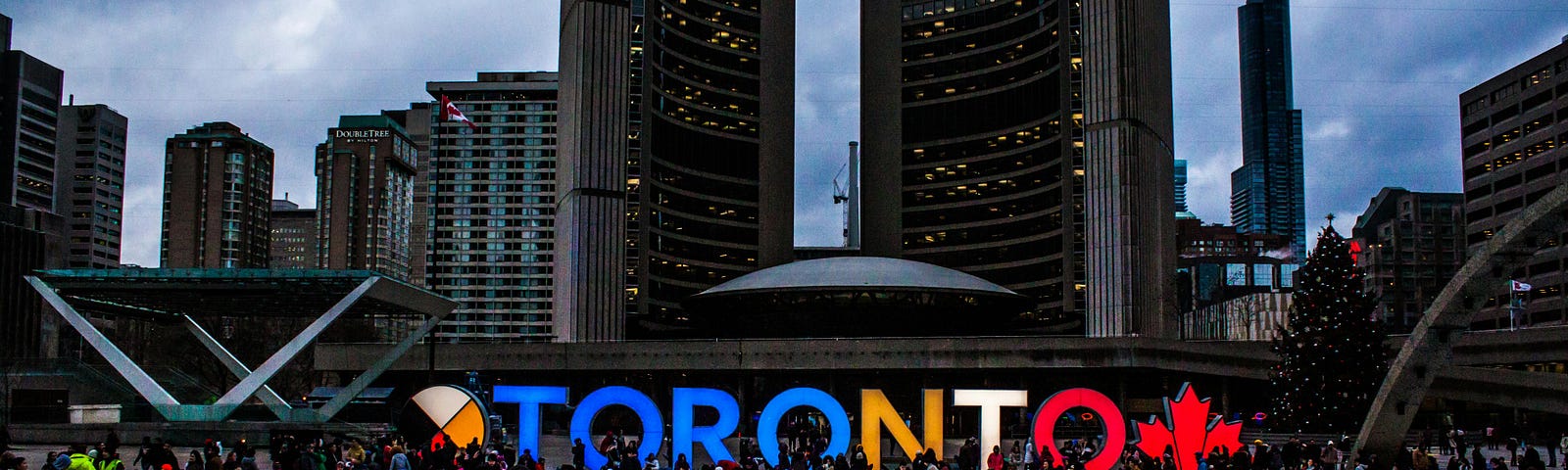 People Gathered in Front of Toronto Freestanding Signage