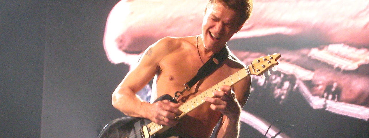 Eddie Van Halen playing guitar onstage