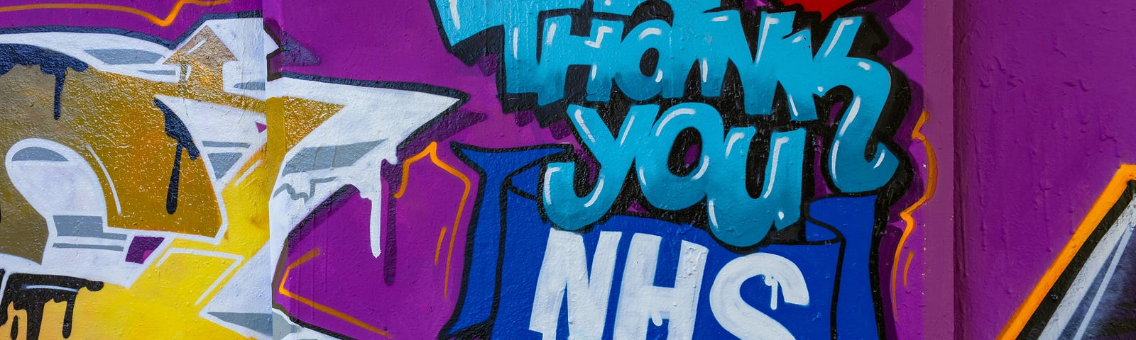 Photograph of a wall of graffiti that reads ‘Thank-you NHS’