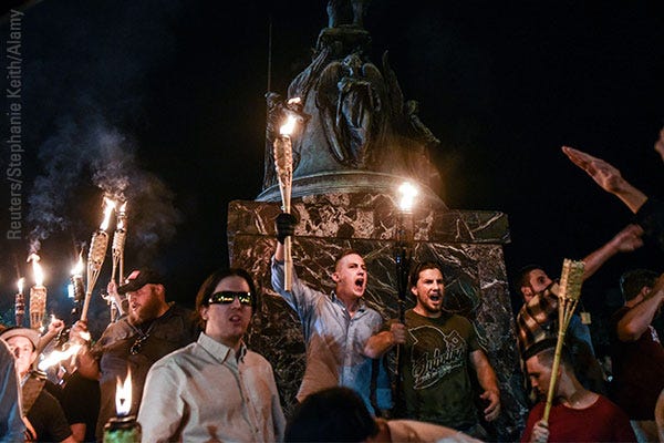 White nationalists participate in a torch-lit march on the grounds of the University of Virginia ahead of the Unite the Right Rally in Charlottesville, Virginia, on August 11, 2017.