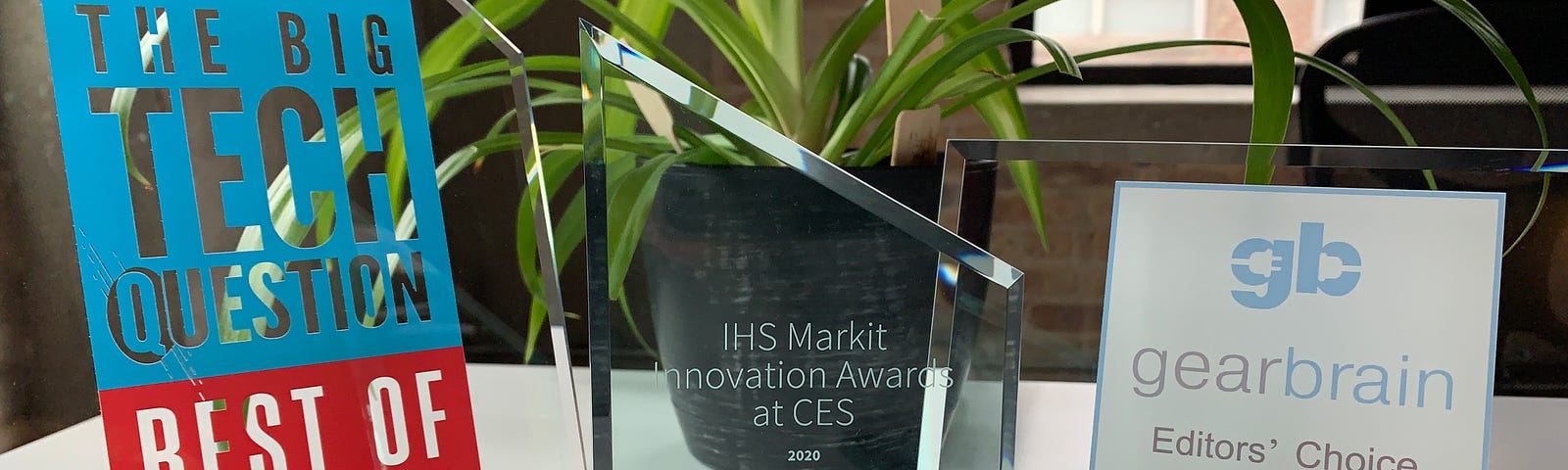 A collection of three different innovation awards on a table