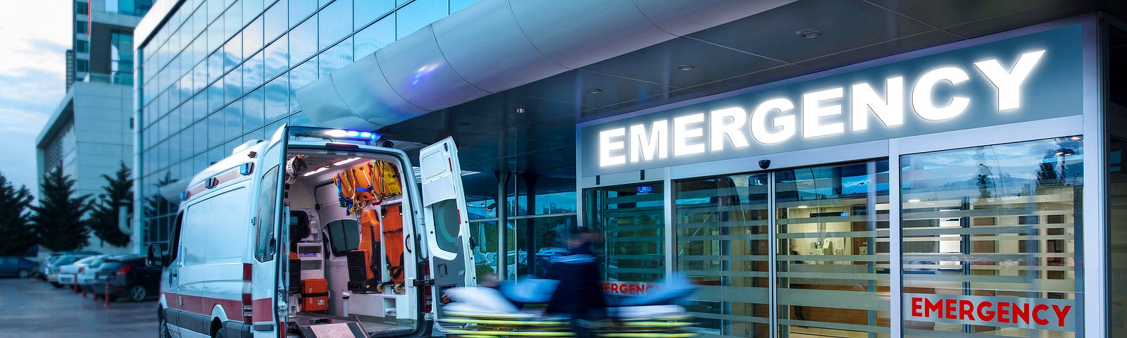 Emergency room entrance with an ambulance unloading a patient. Photo by JazzIRT/Getty Images