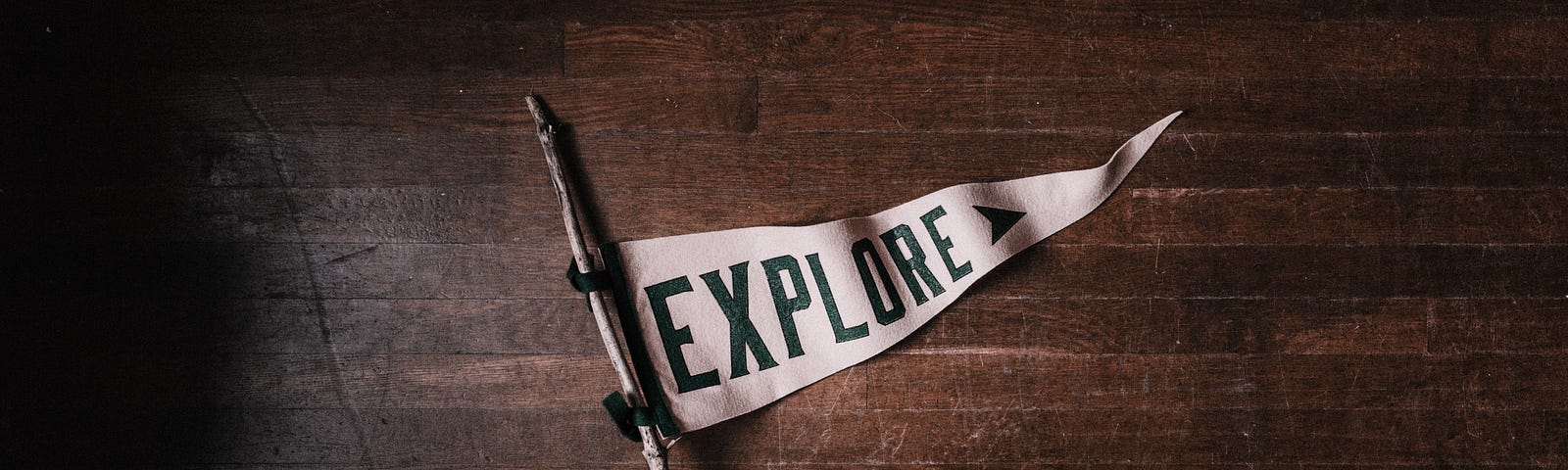 White pennant flag that says “EXPLORE” in all caps