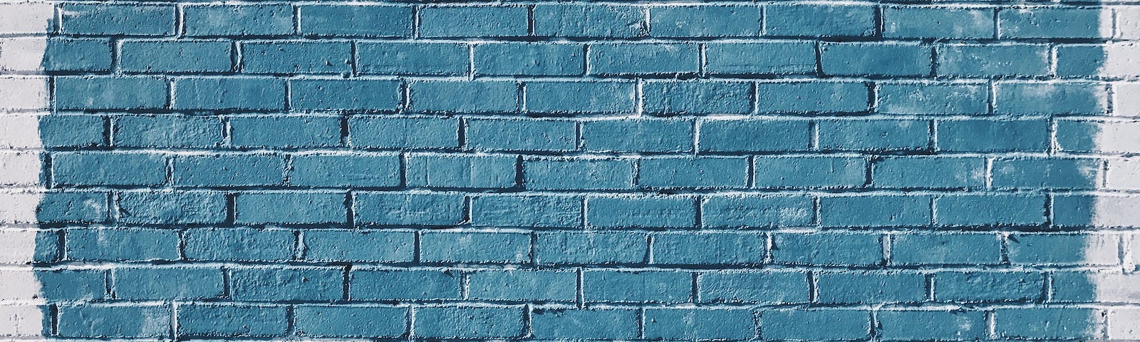 IMAGE: A white brick wall with a square painted in a blue tone