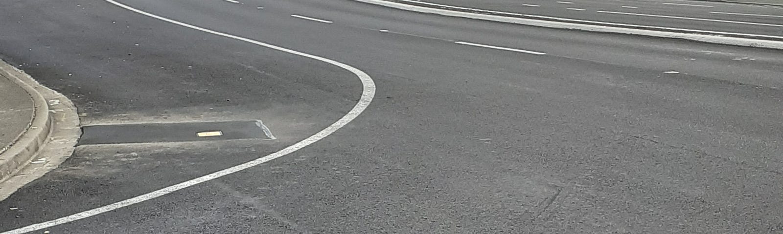 View of empty road, city in distance