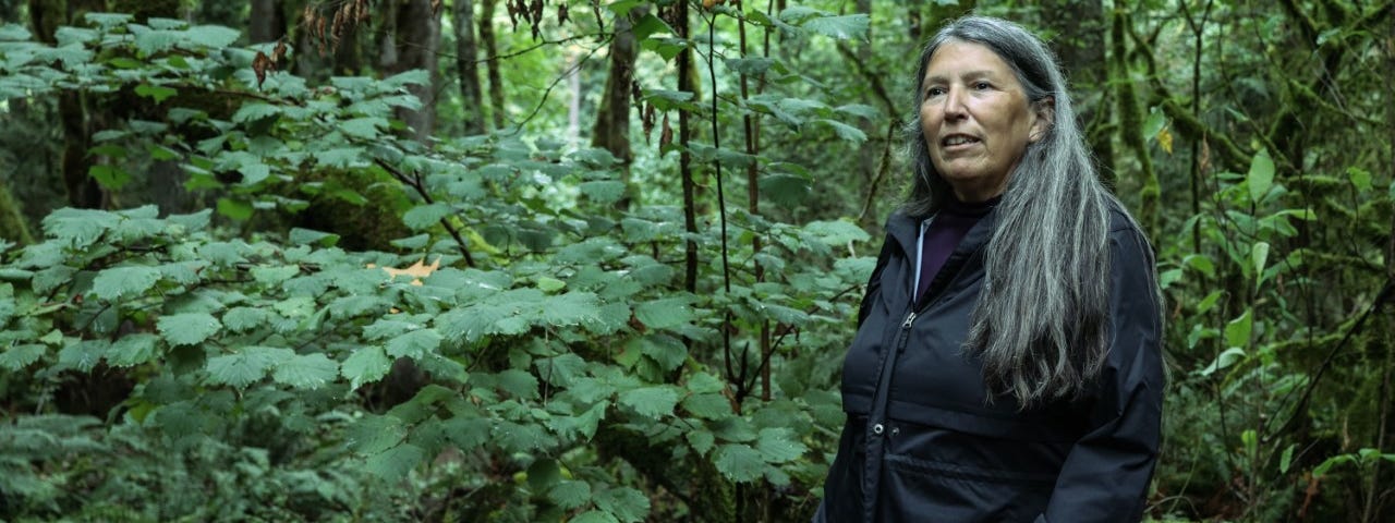 Judy standing in the forest