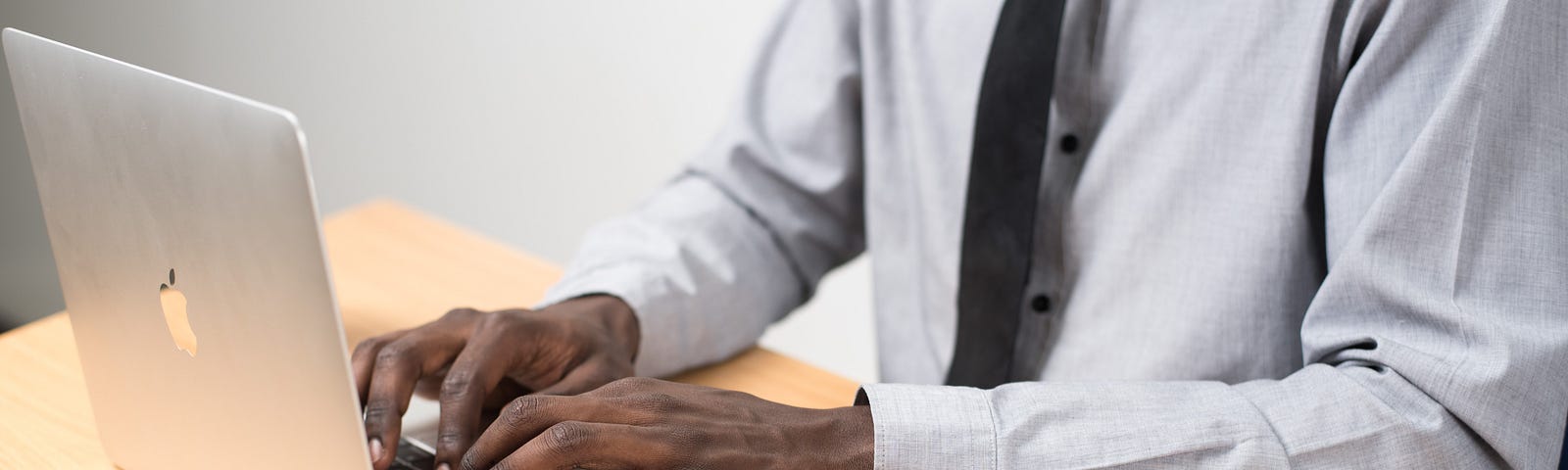 Man working at laptop with mobile phone