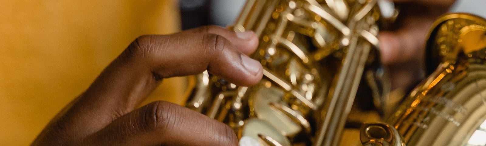 Black skinned hands playing saxophone