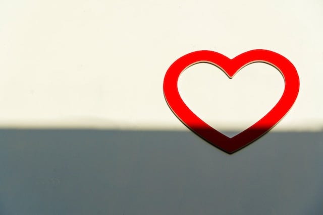 FLoating red heart with a background that goes from dark to light.