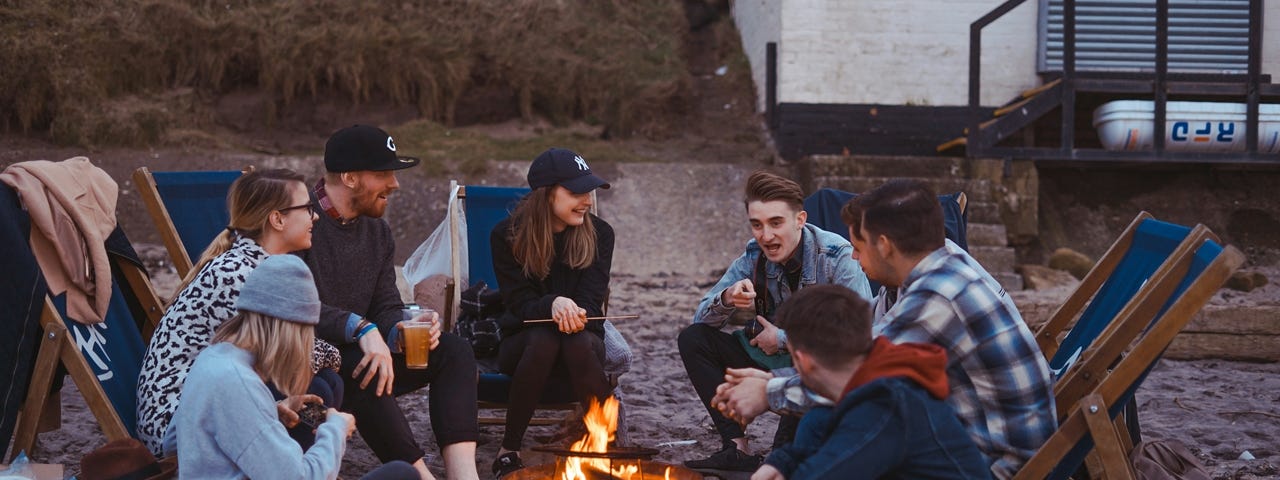 Friends sitting around a fire pit