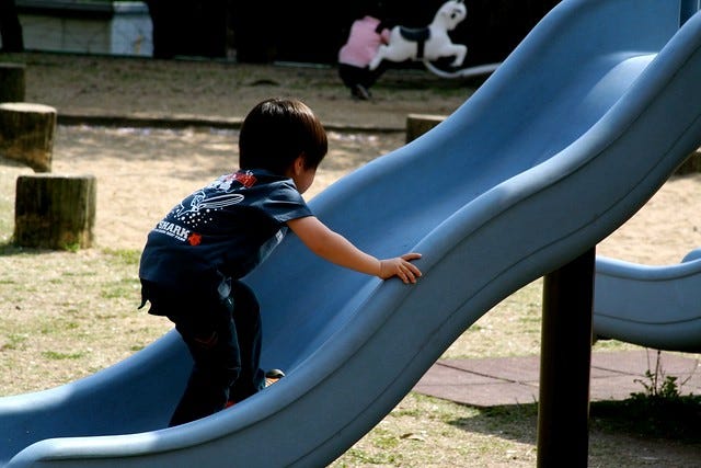 Child climbing a slide