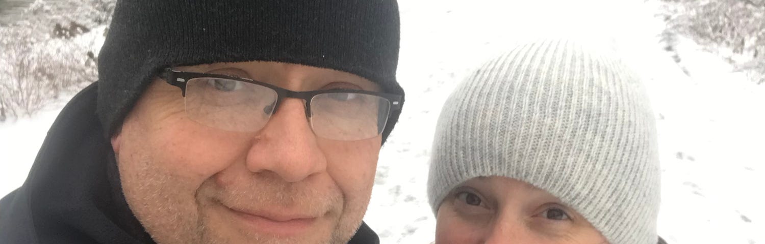 A gen-x couple taking a selfie outside on a winters day.