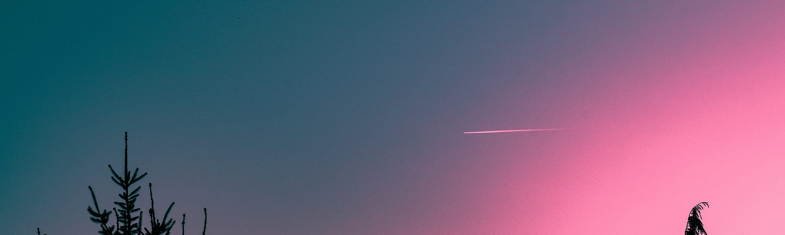 A pink shaded sky with a plane.