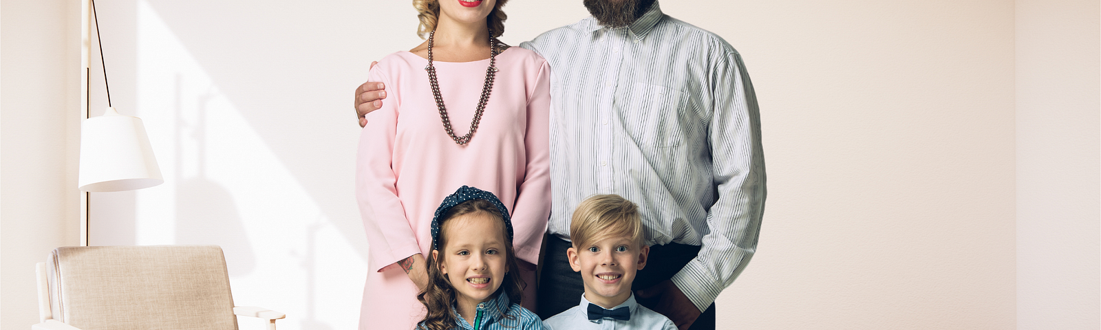 traditional family, husband wife, 2 kids — girl and boy — standing in a living room