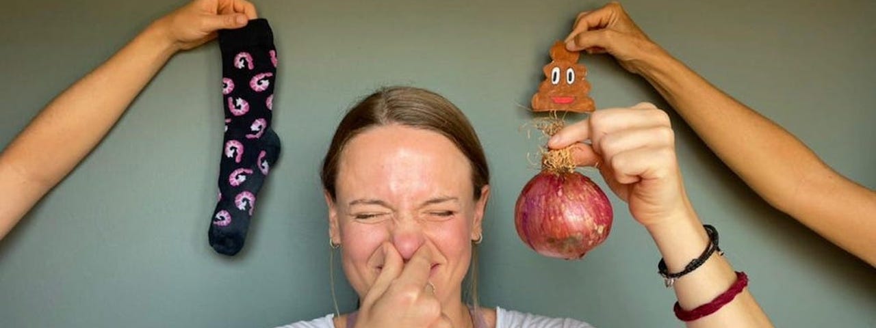 The author holds their nose while holding an onion.