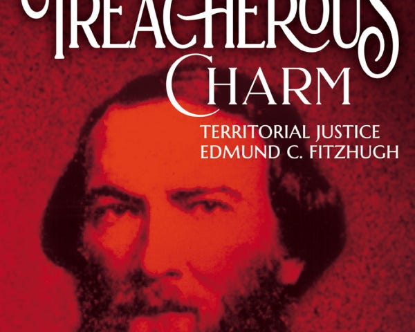 A book cover is shown with a reproduction of an old photograph with a red filter. The portrait photo is of a man with medium length hair and a bushy mustache and beard. He appears to be wearing a shirt and jacket and looks directly into the camera. The title of the book appears at top in white text and reads, “Man of Treacherous Charm: Territorial Justice Edmund C. Fitzhugh.” The author’s name is at bottom in white text and reads, “Candace Wellman.”