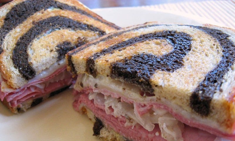 The Reuben Sandwich with corned beef, sauerkraut, Swiss cheese, dressing, on marbled rye comes with crispy fries not pictured.