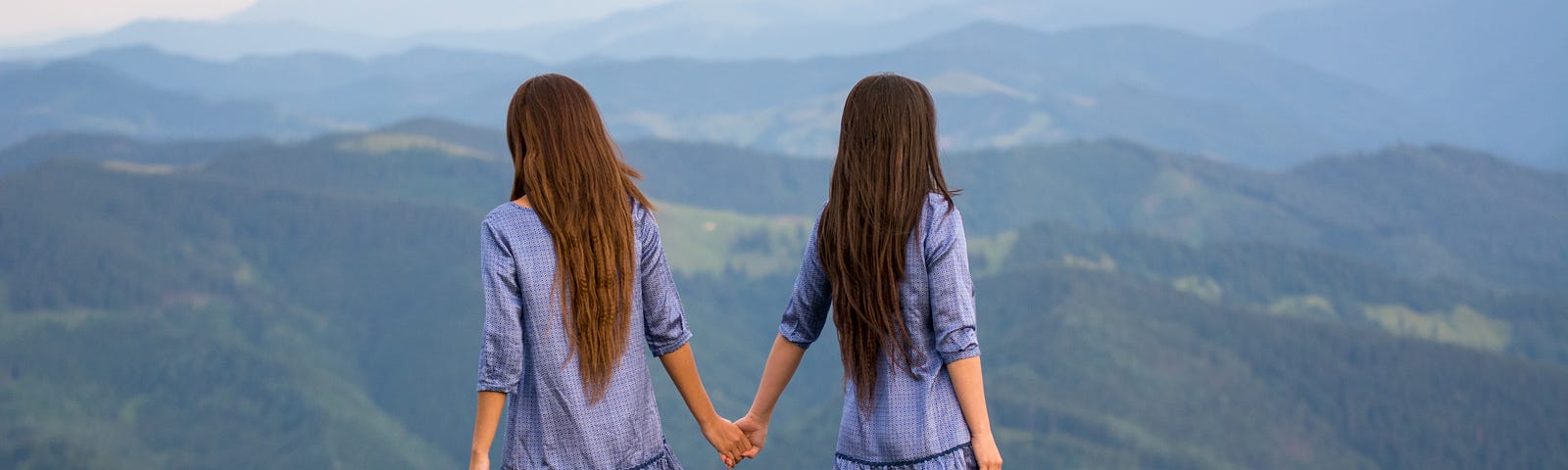 Two women looking over the mountains