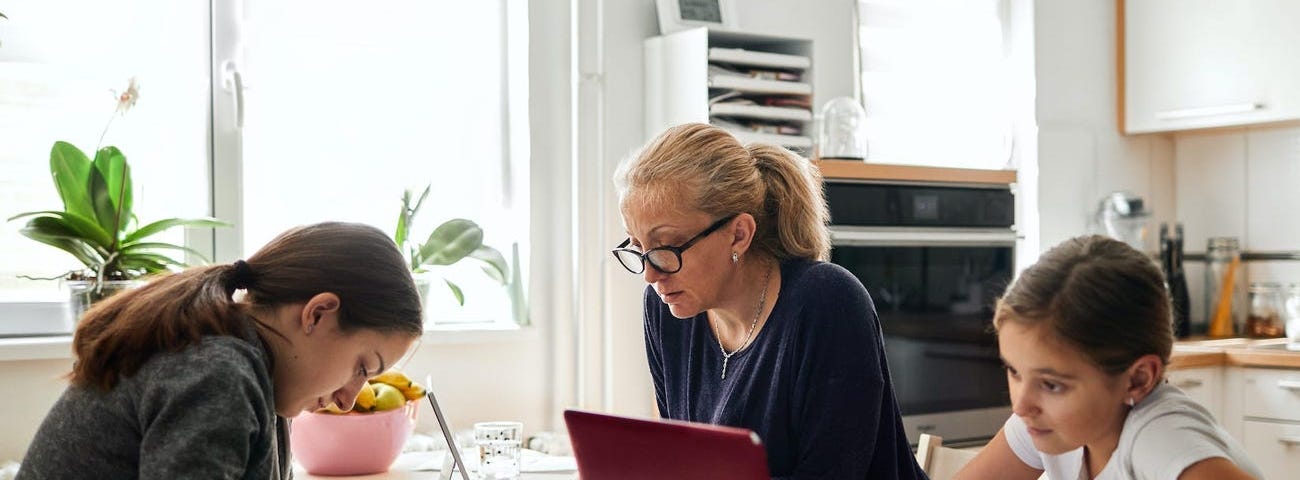 Parents working with children at the table.