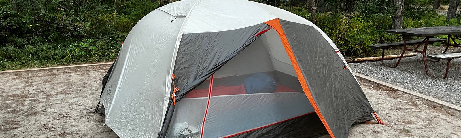 a backpacking tent on a sand tent pad at the West Glacier KOA