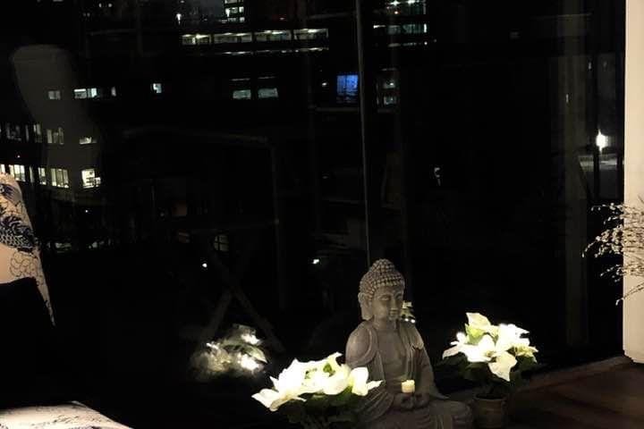 My Buddha statue with plants and candles
