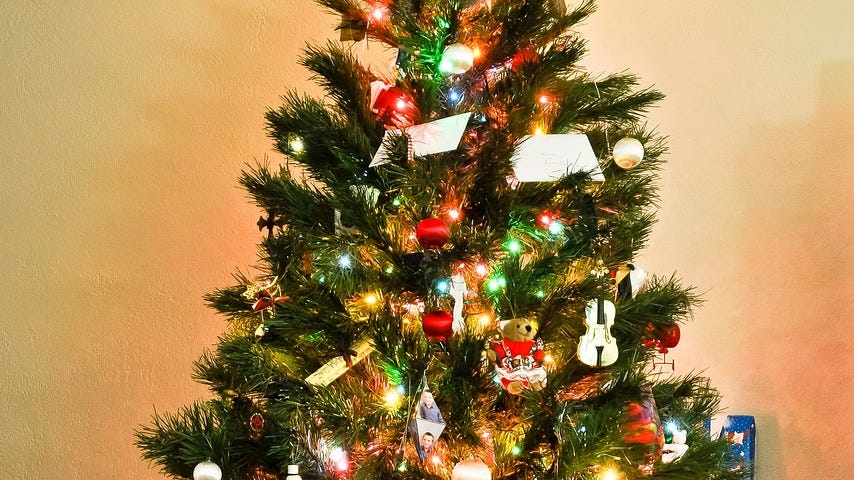 A decorated Christmas tree surrounded by presents.