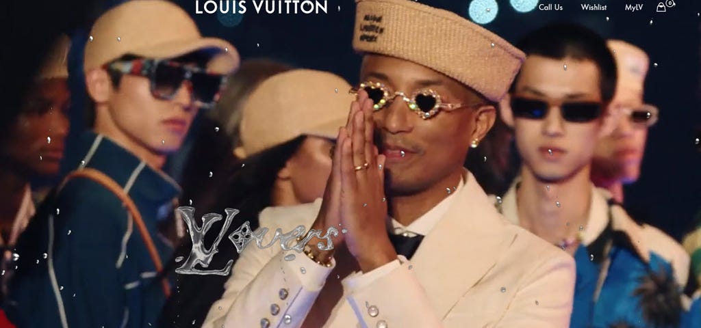 Closeup of Pharrell Williams getting applause at his Louis Vuitton fashion show