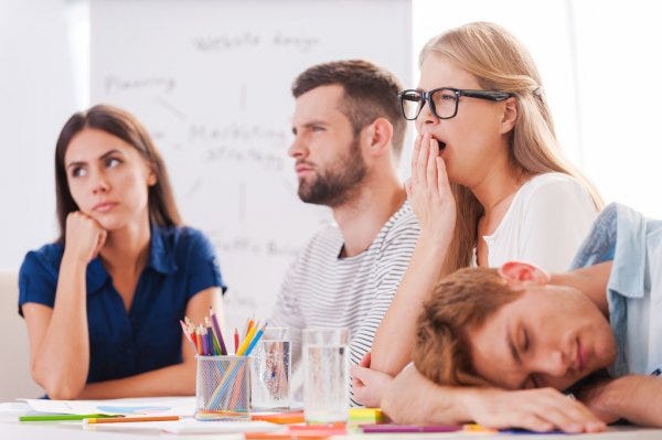 People bored and asleep in a meeting