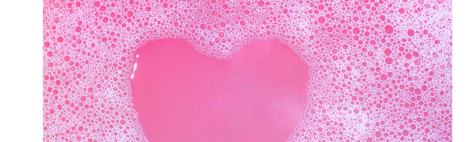 Soap bubbles shaped into a pink heart