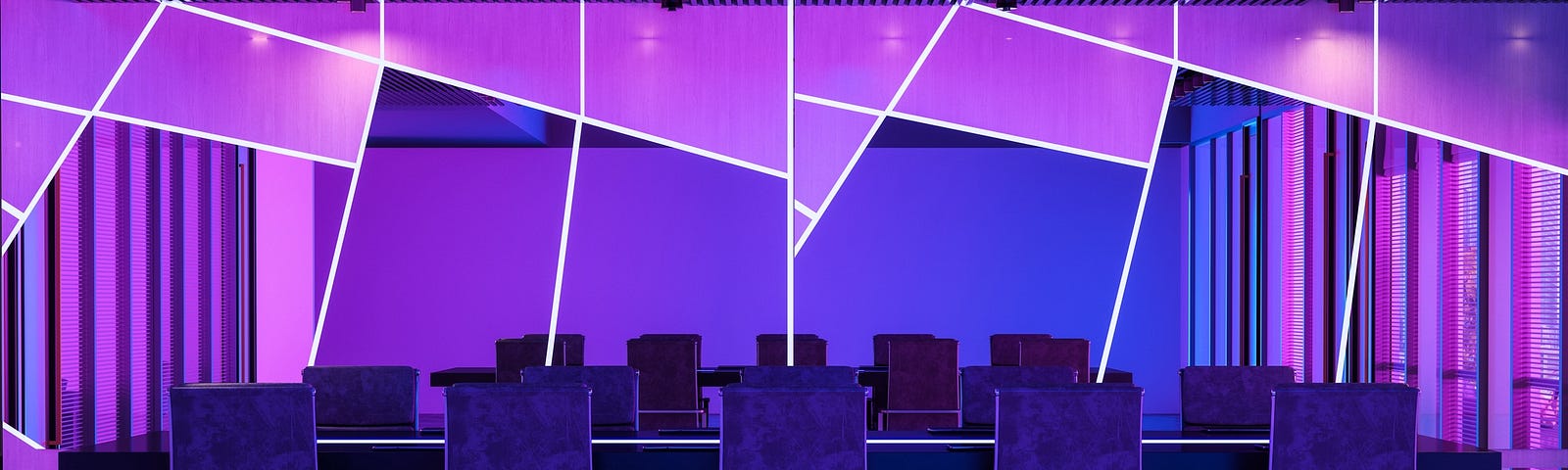 Cover image depicting a board room with empty seats all in shades of purple.