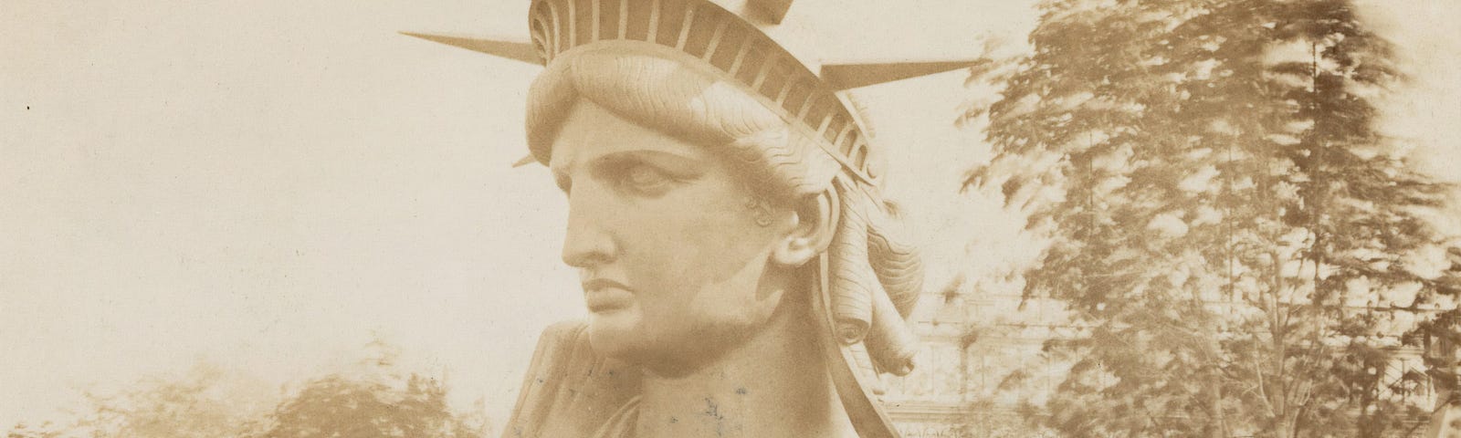 Head of the Statue of Liberty on display in a park in Paris.