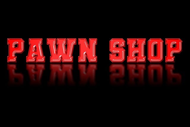The word “Pawn Shop”, red against black, with its reflected image below.