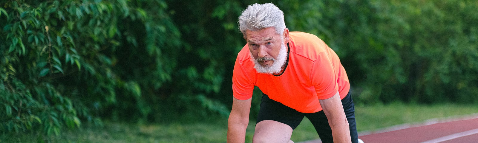 Man at starting line of race; he’s an older man, perhaps attempting a comeback