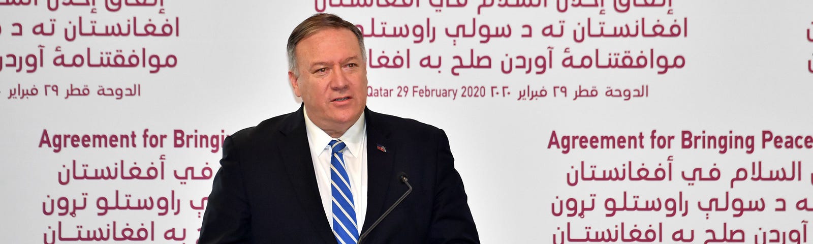 Then US secretary of state Mike Pompeo stands at a Podium Against a background that reads ‘Agreement for Bringing peace to Afghanistan’.