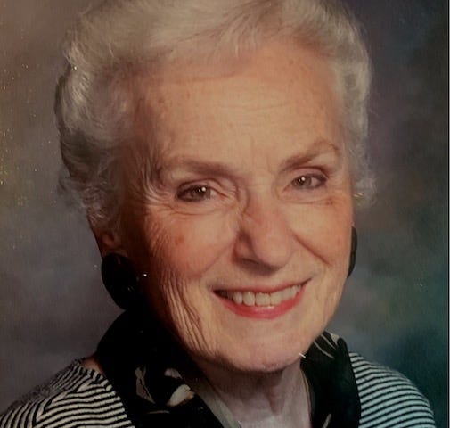 A portrait of a smiling older white woman