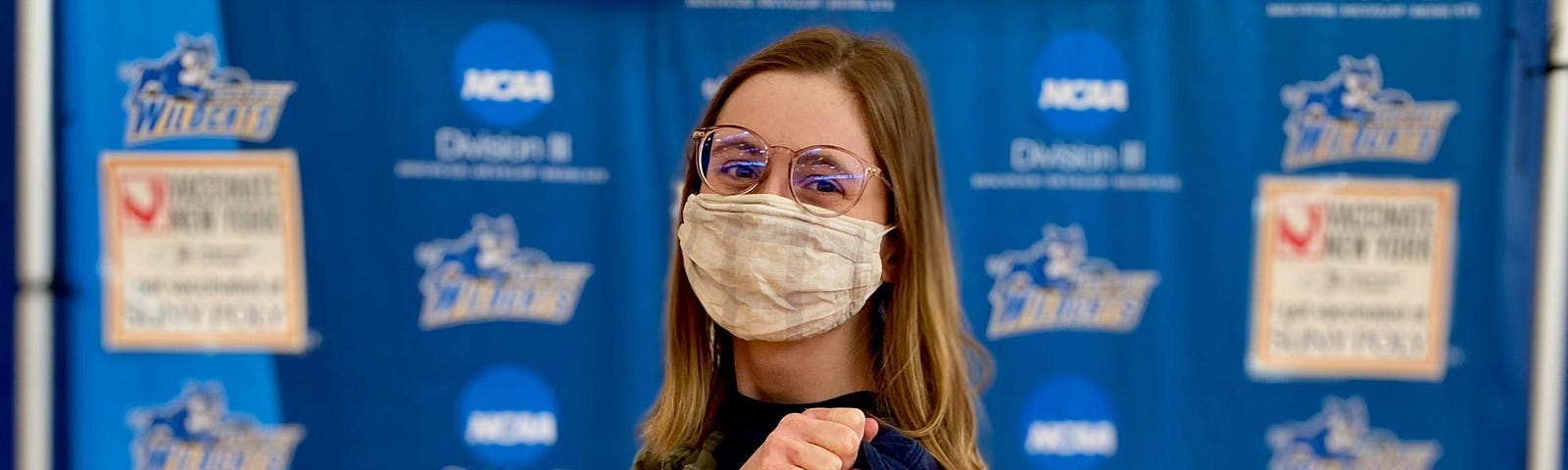 The author shows off a bandaid on her arm, where she got her booster shot.