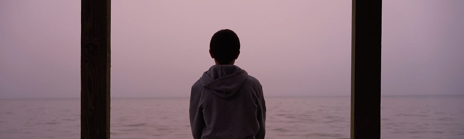 A person sitting lakeside.