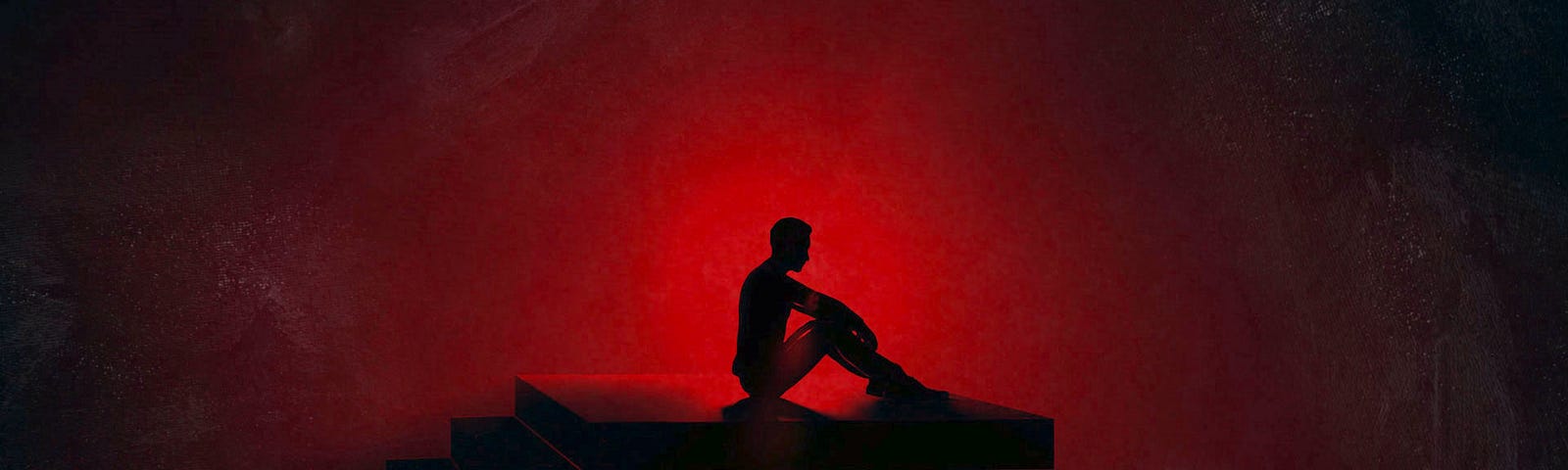 A person sitting on a staircase in a dark dystopian area backlit by an ominous intensely bright crimson red light.