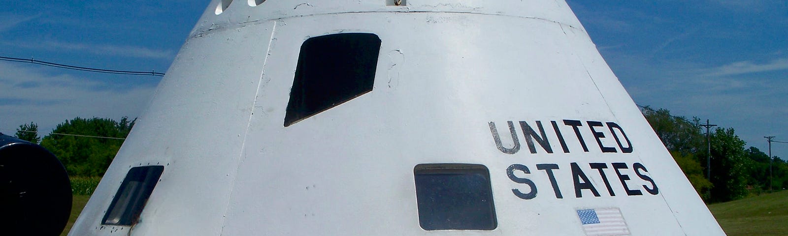 A white triangular vehicle with United States on the side. Lunar module. Neil Armstrong Air and Space museum, Ohio.