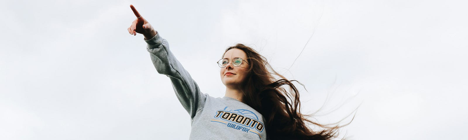 woman pointing using her left hand