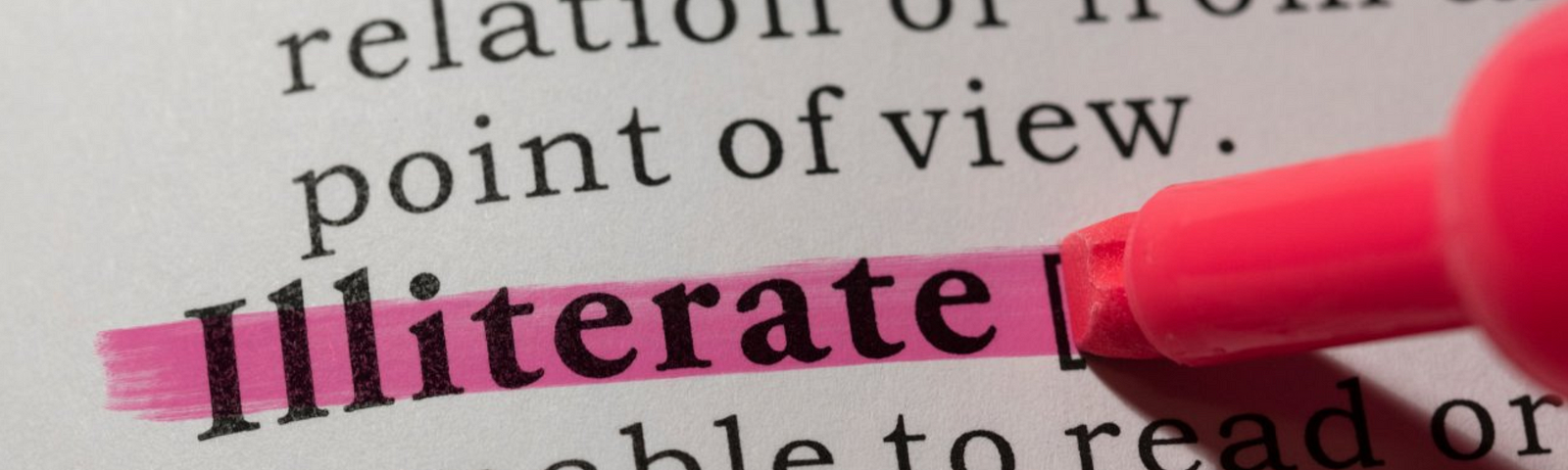 Pen highlighting the word “illiterate”