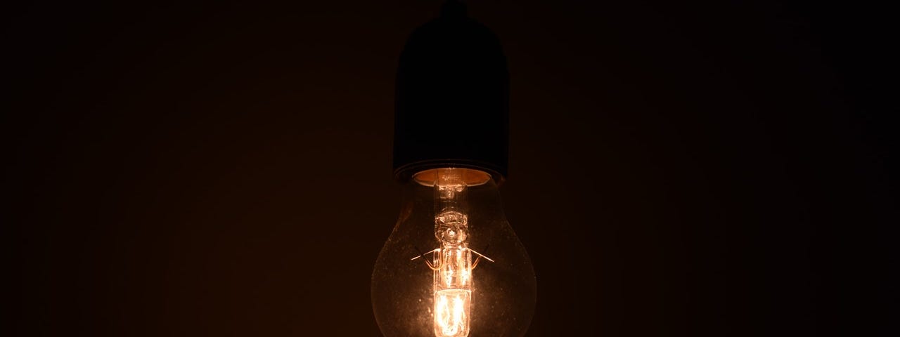 Vintage lightbulb in darkness