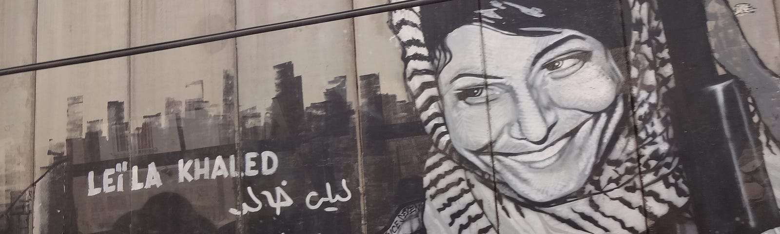 Palestinian freedom fighter Leila Khaled, artwork on the Israeli Apartheid Wall in Bethlehem, Palestine (Photo by Bluewind, Licensed under Creative Commons 3.0).