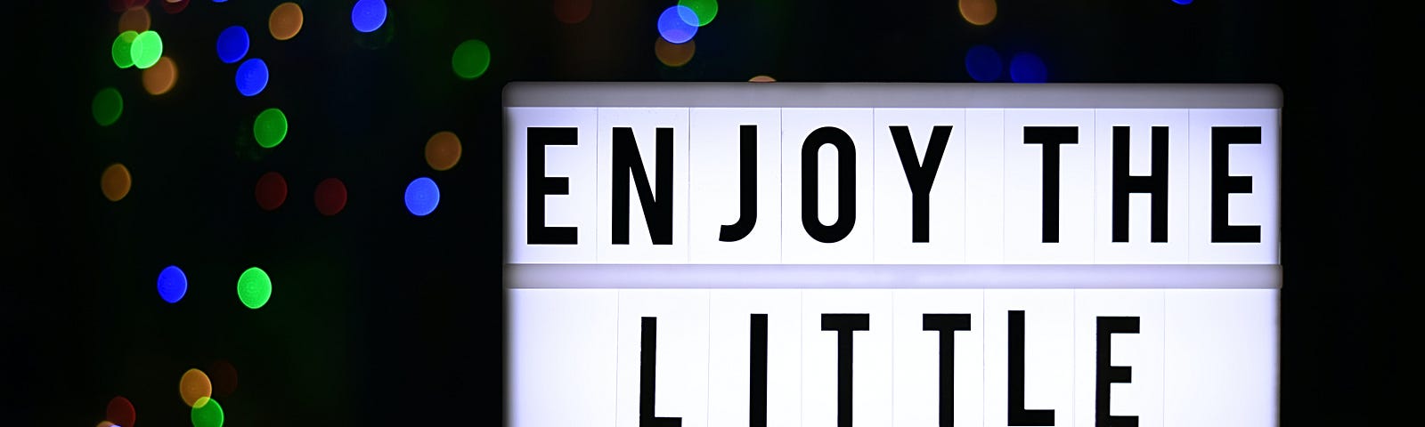 A sign saying Enjoy the Little Things