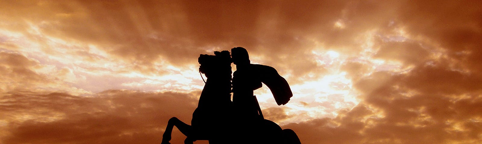 A statue of Alexander the Great on his horse at sunset