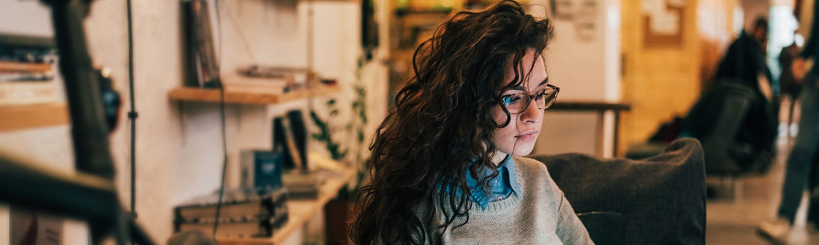 Young woman writes on laptop for Medium